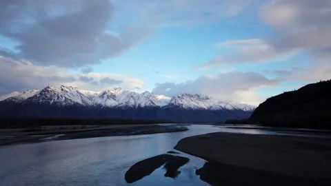 Timelapse of clouds passing over snowy mountains and the Knik river Alaska Stock Footage 131844894