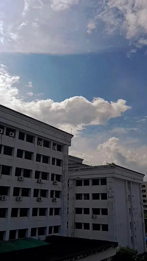 Timelapse of Clouds Passing Over White City Buildings Under Blue Sky Stock Footage 340410434