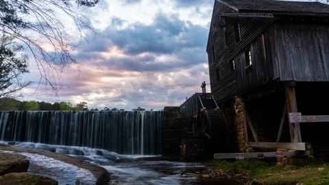 Timelapse of clouds passing over Yates Mill in Raleigh NC at sunset Stock Footage 113769364