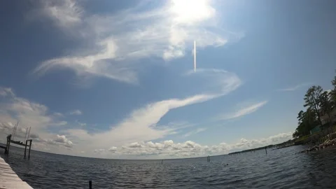Timelapse of clouds, with passing sun, over large body of water. Stock Footage 161195355