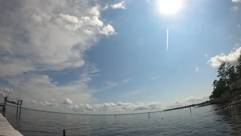Timelapse of clouds, with passing sun, over large body of water. Stock Footage 161195545