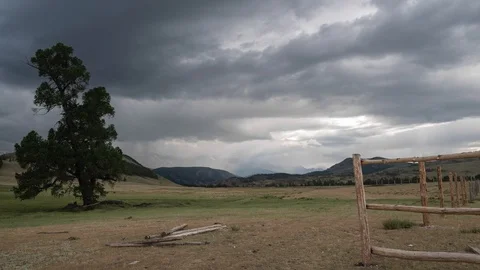 TimeLapse. Clouds with rain cover the snow-capped mountains in the background. A Video stock 93940973