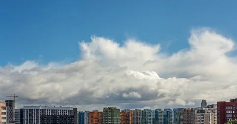 Timelapse of clouds rapidly running across blue sky over modern city district Stock Footage 160589534