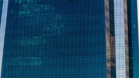 Timelapse of clouds reflected in a curtain wall facade of a business building Stock Footage 170855610