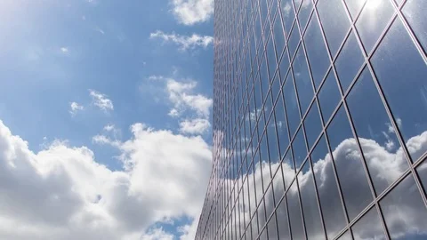 Timelapse of clouds reflected in the many mirrored facets of a office building Stock-Footage 83266839