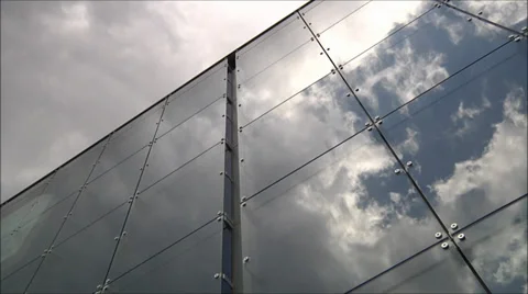 Timelapse of clouds reflected in the mirrored facets of a office building. Stock Footage 31751958