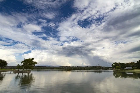 Timelapse of clouds reflecting off the calm water of Inks Lake, Texas. Stock Footage 96201875