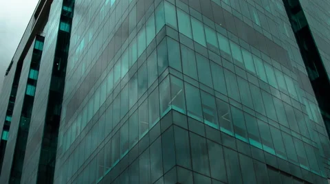 Timelapse of clouds reflecting in green glass windows Stock Footage 41895045