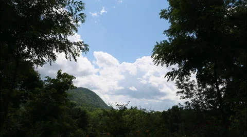 Timelapse of clouds rolling across the side of a mountain, 4K Stock Footage 65497868