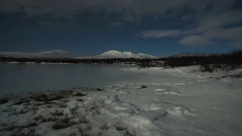 Timelapse of clouds rolling over frozen lake Stock Footage 73011747