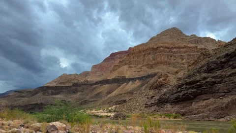 Timelapse of clouds rolling over mountain and river. bottom of the grand canyon Stock Footage 310921985