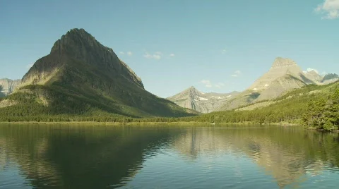 Timelapse of clouds rolling over a rugged mountains with lake Stock Footage 520606