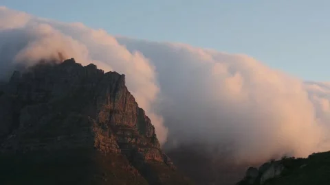 Timelapse of clouds rolling over Table Mountain at sunset in Cape Town. Stock Footage