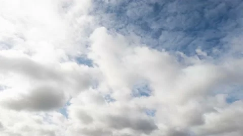 Timelapse of clouds running across blue sky Stock Footage 143921379