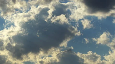 Timelapse of clouds running across blue sky at day time Stock Footage 194498703