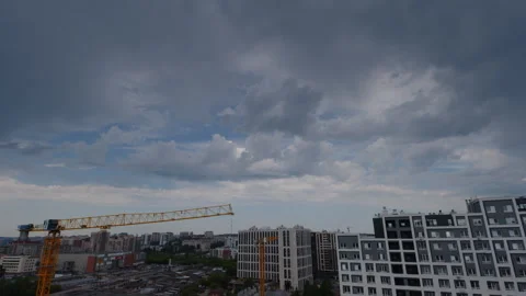 Timelapse of the clouds running fast over the buildings in a city Stock Footage 340432252