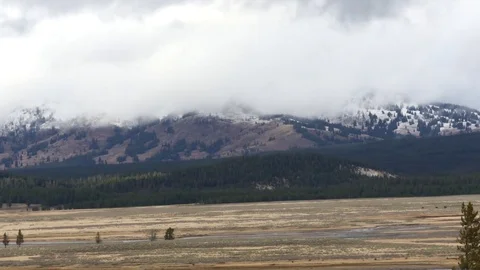 Timelapse of clouds sailing on snowy mountains, in Yellowstone national par.. Stock Footage 71751368