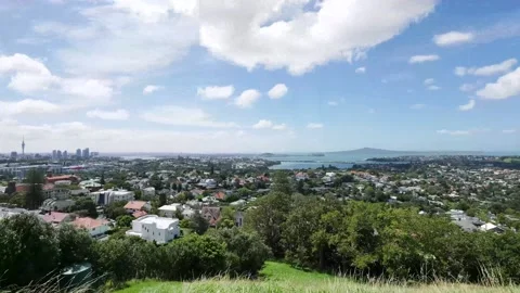 Timelapse of clouds skidding over a very green urban environment Stock Footage 233216181
