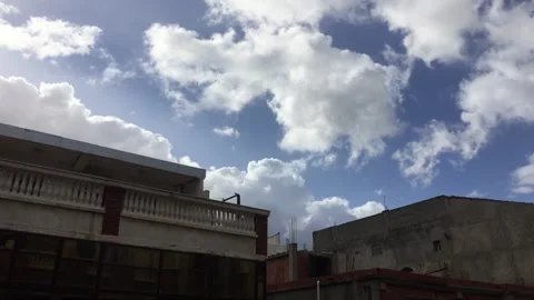 TimeLapse of clouds in the sky between buildings Stock Footage