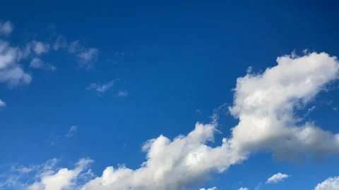 Timelapse clouds, smallish white fluffy pattern in blue sky flows to low R. Stock Footage 286167803