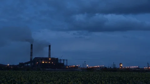 Timelapse of clouds of smoke billowing from smokestacks into the twighlight sky Stock Footage 113738966