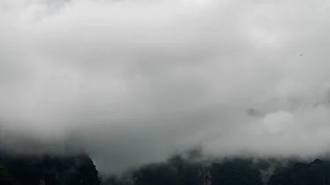Timelapse of clouds surronding the cliff. Fog revealing mountain. Stock Footage 112166552