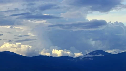 Timelapse Clouds swirl over blue mountains, snowy peak in the distance. Stock Footage 162481513