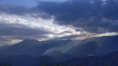 Timelapse of clouds on top of the mountains during sunset Stock Footage 168277978