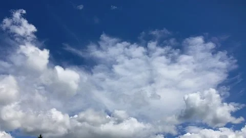 Timelapse clouds, two slow layers develop in blue sky Stock Footage 286167274