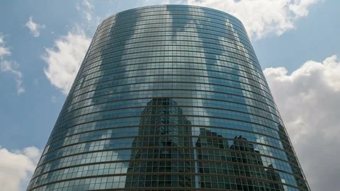 Timelapse of Cloudscape over Round Reflective Building in Tokyo -Zoom In- Stock Footage