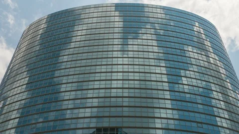 Timelapse of Cloudscape over Round Reflective Building in Tokyo -Zoom Out- Stock Footage