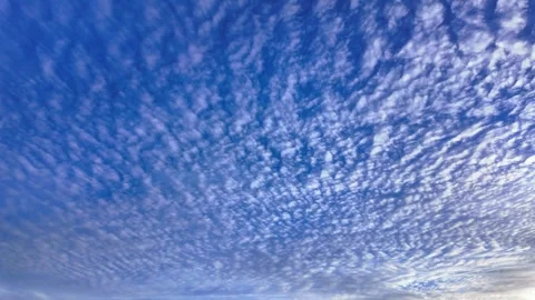 Timelapse cloudscape with wispy cirrus clouds against a vibrant blue sky Stock Footage 288544753