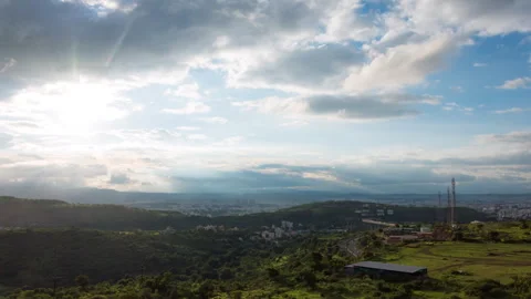 Timelapse - Cloudscapes over a city during golden hour 4K60 Stock Footage 271019217