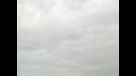 Timelapse of cloudy layered clouds moving on white bright sky to darker sky Stock Footage 294919422