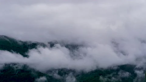 Timelapse of the cloudy sky in the mountains. The clouds are floating fast Stock Footage 134538574