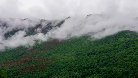Timelapse of the cloudy sky in the mountains. The clouds are floating fast Stock Footage 134539437