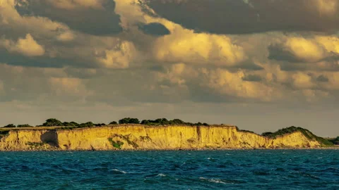 Timelapse of the cloudy sky over the cliffs of the peninsula Hindsholm Stock Footage 166316500