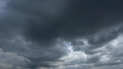 Timelapse of cloudy sky with white clouds and dark grey heavy rainy clouds Stock Footage 129034678