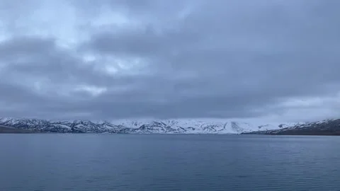 Timelapse of a Cold Lake and Snow-Capped Mountains Under Grey Clouds China 스톡 동영상 338311719