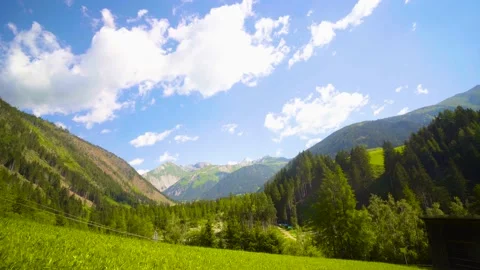 Timelapse of colorful Austrian landscape with multiple green/grey mountains 4K Stock Footage