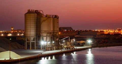 Timelapse of concrete towering silos on a dock in Manama Stock Footage 116504711