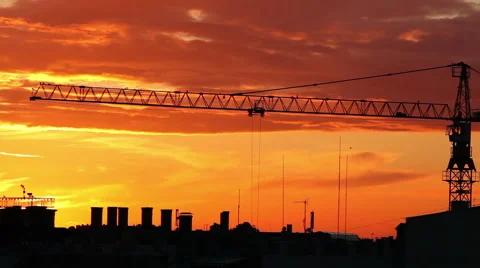 A timelapse of construction crane in action over a city skyline silhouette Stock Footage 41337769