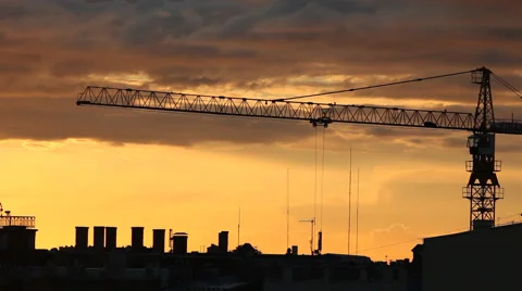 A timelapse of construction crane in action over a city skyline silhouette Stock Footage 41338361