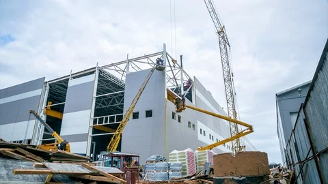 Timelapse construction of storehouse with cranes against sky Stock Footage 103296341