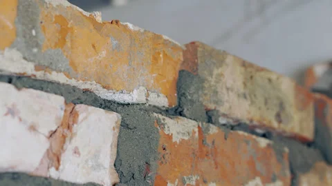 Timelapse A construction worker erects a brick wall. Stock Footage 239630645