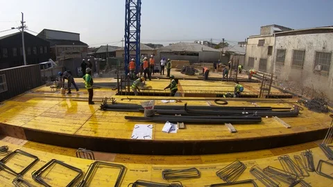Timelapse of construction workers on the deck of a building fixing steel befo Stock Footage 115691820