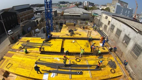 Timelapse of construction workers on the deck of a building fixing steel befo Video stock 115692477