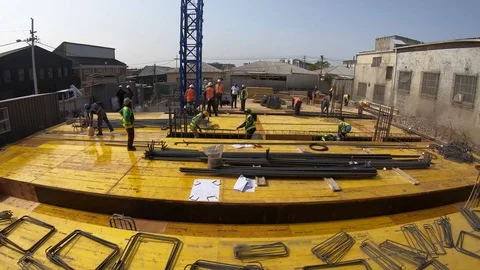 Timelapse of construction workers on the deck of a building fixing steel befo Video stock 117067297