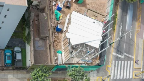 Timelapse to Construction workers installing roof panels on building frame Stock Footage 314470580