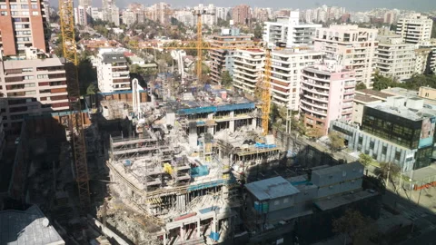 Timelapse of construction workers using cranes on a building Stockbeeldmateriaal 245735917
